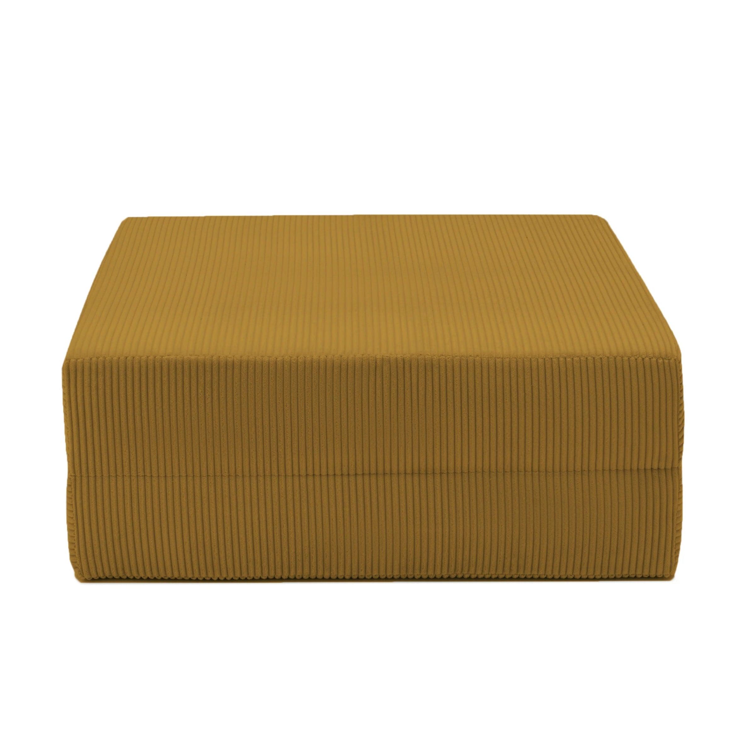 Mustard yellow ribbed ottoman on a white background