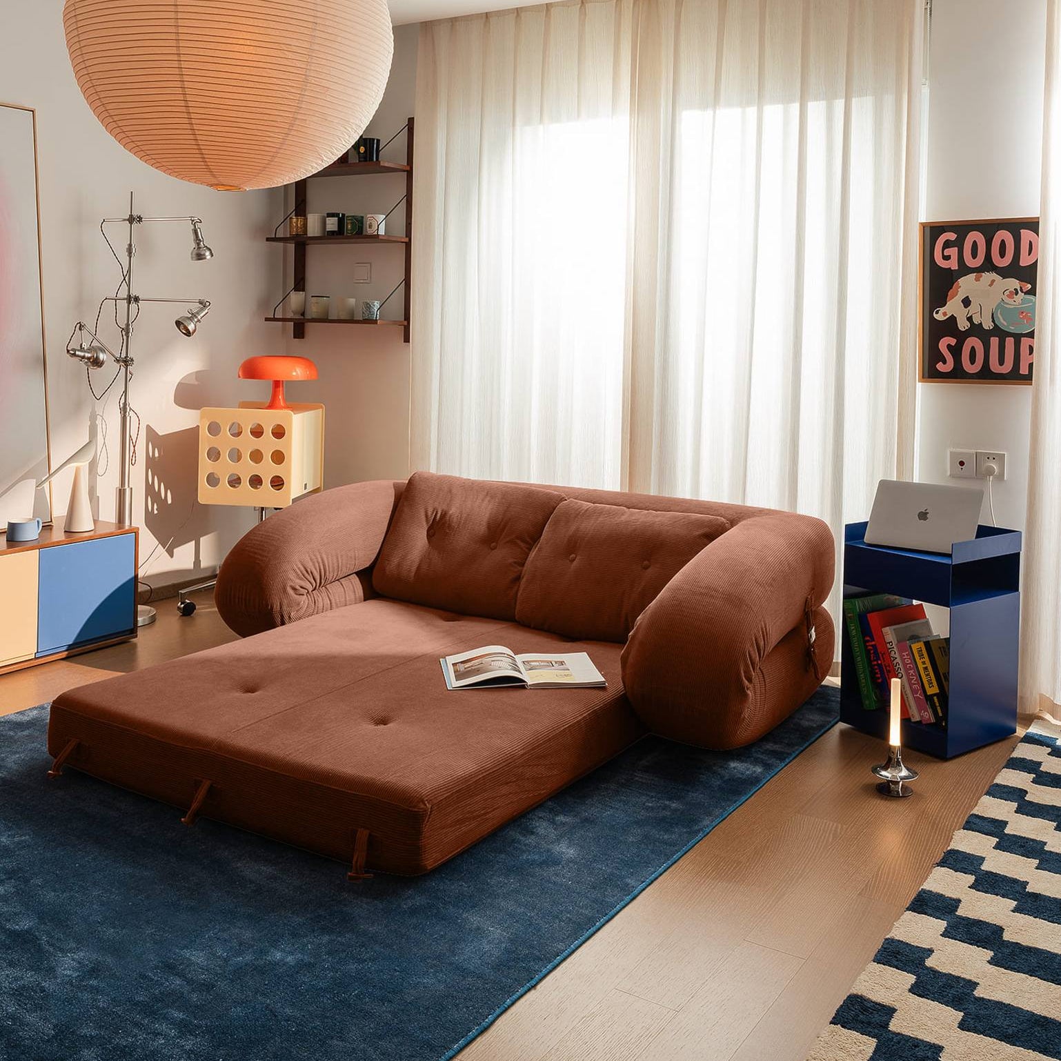 Modern living room with a brown sectional sofa, pendant light, and decor items.