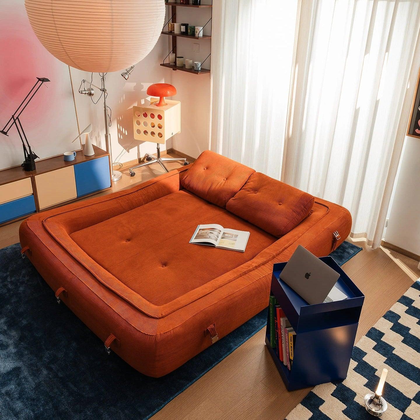 Flippo Sofa Bed in Orange color – sculptural design with plush corduroy, convertible to bed, modern furniture style
