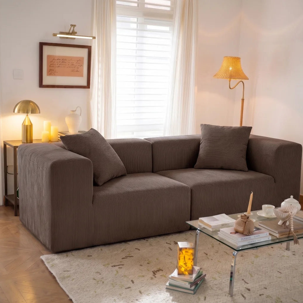 Living room with a brown sofa, coffee table, and decorative items.