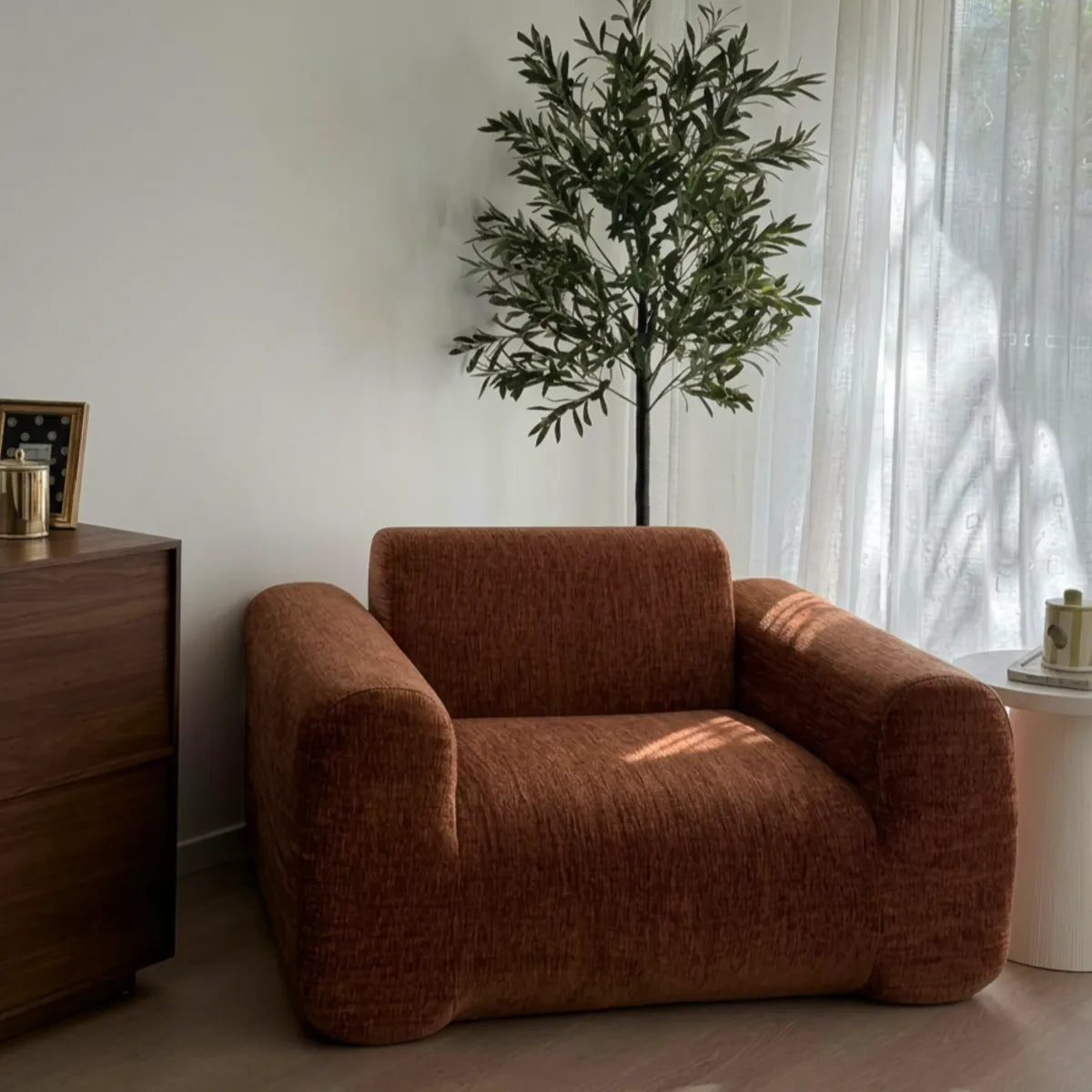 Brown armchair in a room with a plant and furniture