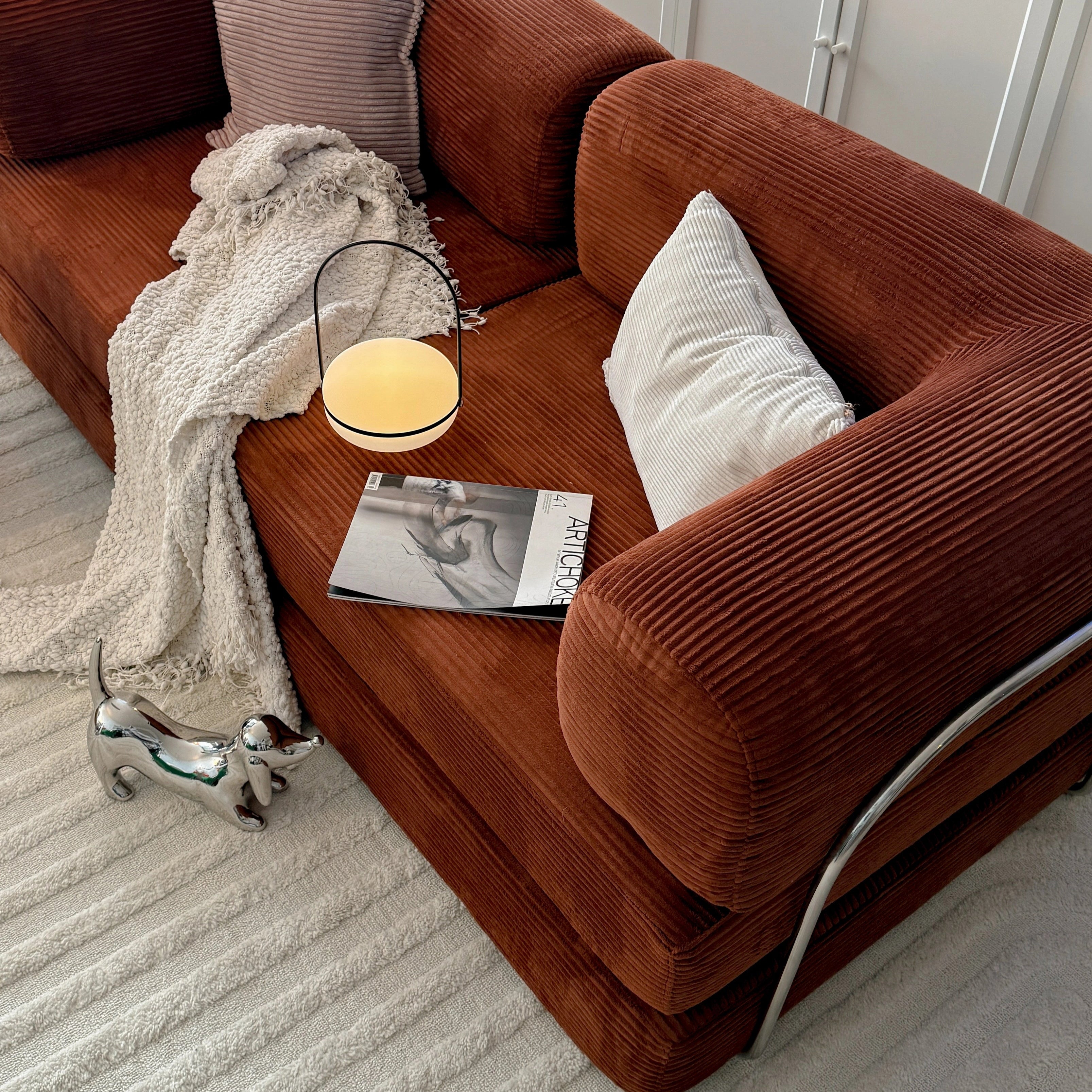 Brown sofa with decorative items in a living room setting