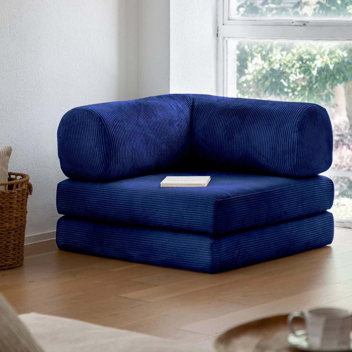 Blue modular sofa in a living room with a window in the background