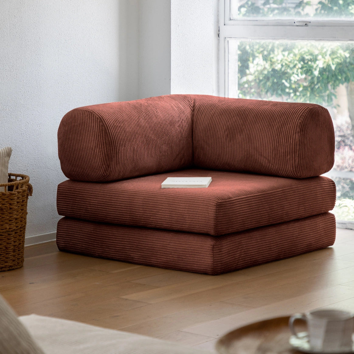 Brown sectional sofa in a living room with a window in the background
