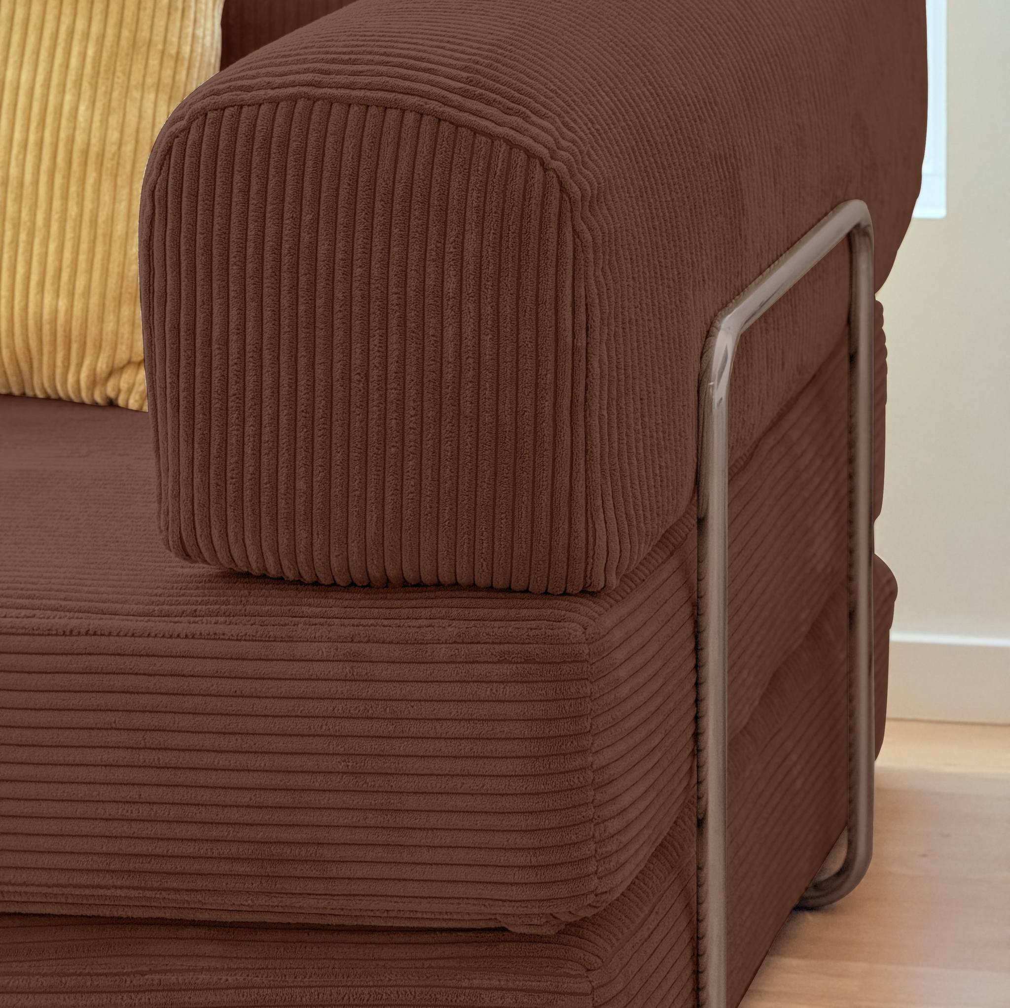 Brown textured sofa with a chair on a wooden floor.