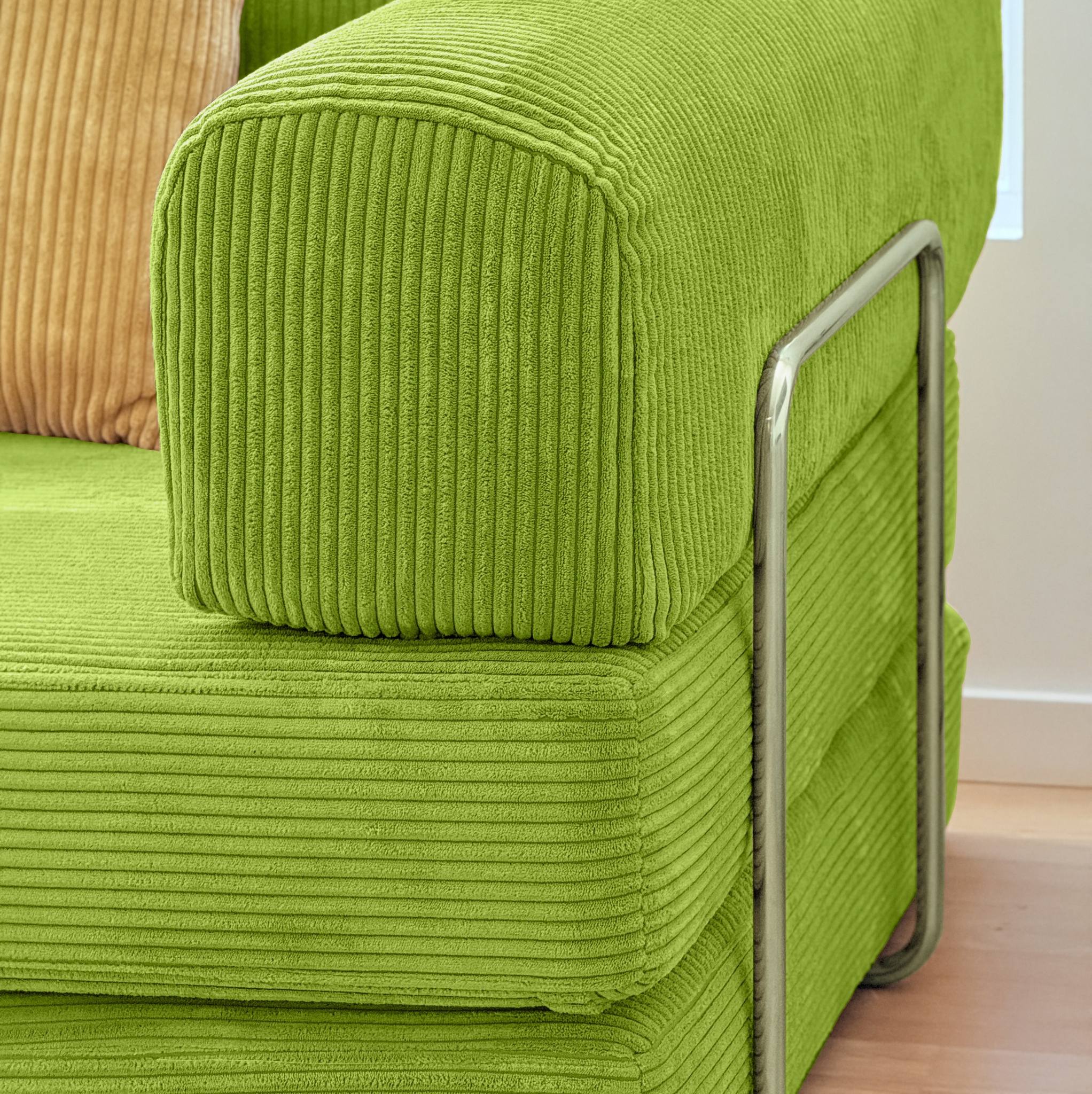 Close-up of a green ribbed fabric chair with a metal armrest.