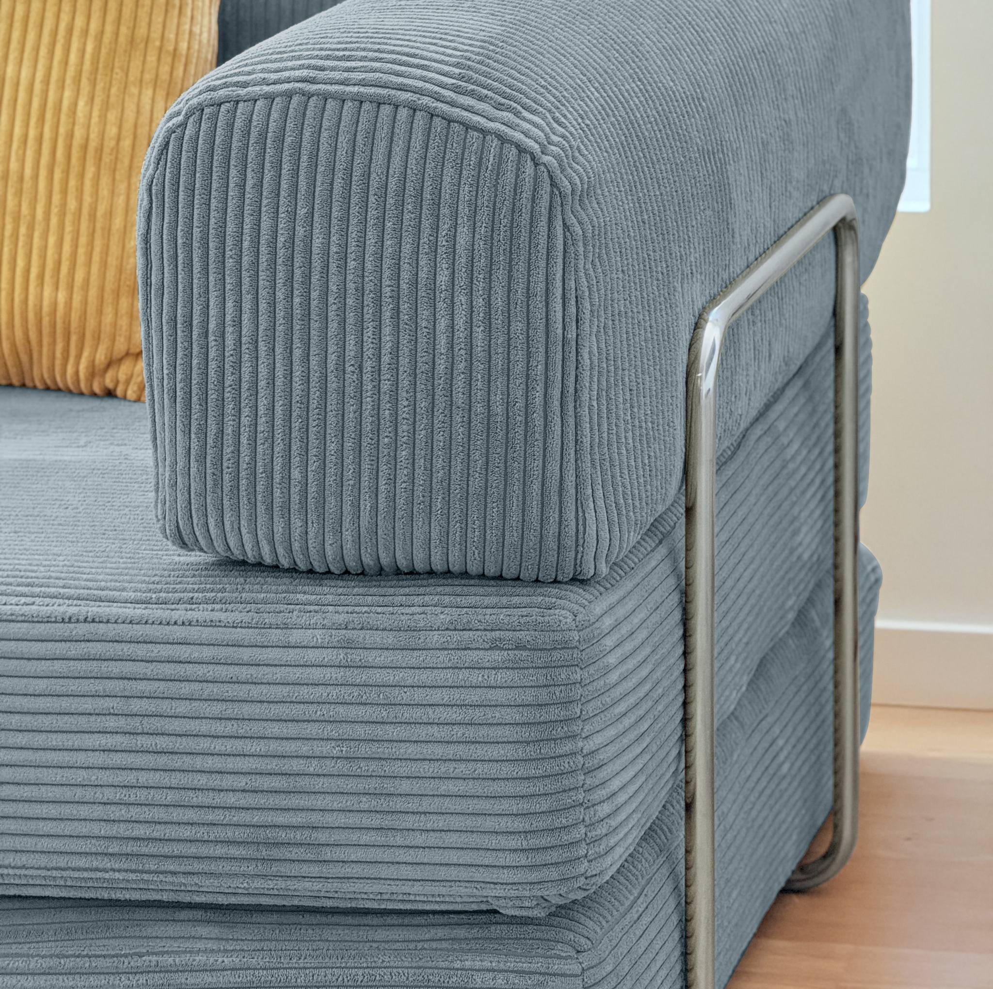 Gray ribbed fabric sofa with a metal armrest on a wooden floor.